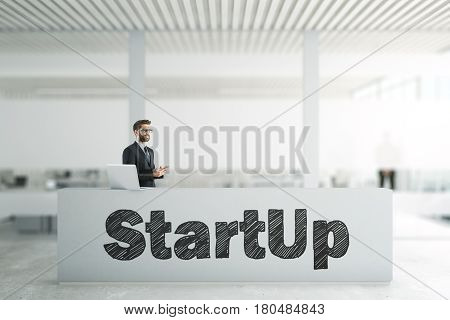 Businessman using cellphone at reception desk with startup writing. Entrepreneurship concept. 3D Rendering