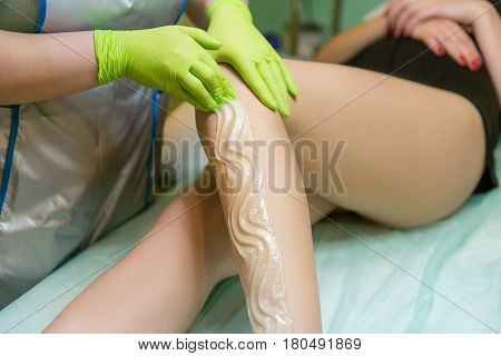 Sugaring Sugar waxing feet in the beauty salon. Depilation of the feet