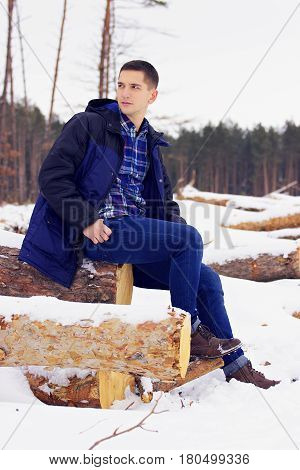 Handsome, Stylish And Young Man In Jacket Sitting On The Woods In The Forest. Early Spring, Sunny Da