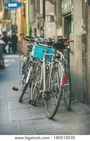 BUDAPEST, HUNGARY - MARCH 26, 2017: Variety of bicycles parked in street near Szimpla Kert ruin pub in Jewish quarter of Budapest, unknown people at background