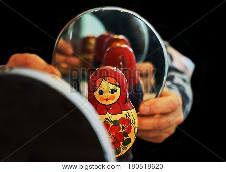 Black background and Matryoshka mirror and reflection