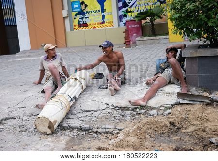 TEBING TINGGI NORTH SUMATRA INDONESIA - DECEMBER 18 2016: Roadworkers take rest after hard working day