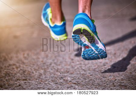 Running athlete during training outdoors in the summer on a sunny day.