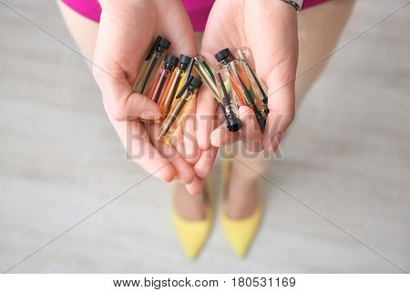 Different perfume samples in female hands