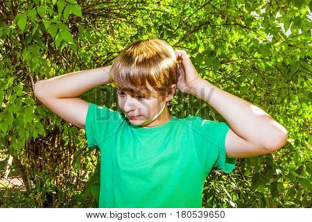 Cute Smart Boy In The Garden Under The  Tree