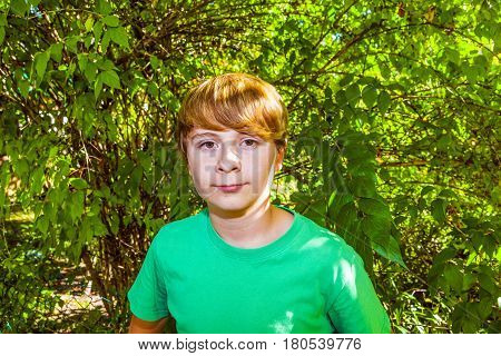 Cute Smart Boy In The Garden Under The  Tree