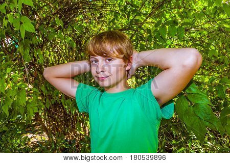 cute smart boy in the garden under the tree