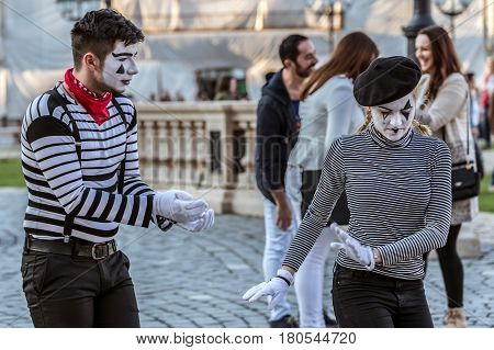 TIMISOARA ROMANIA - MARCH 31 2017: Pantomime couple with painted face present on the street inside the CheckART Carnival organized by the City Hall Timisoara. Union Square.