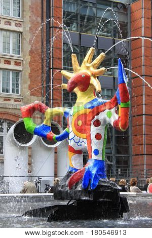 PARIS FRANCE - MAY 24 2015: Jets of water from a colorful sculpture in the Stravinsky Fountain next to the Pompidou Center attract tourists on a spring day