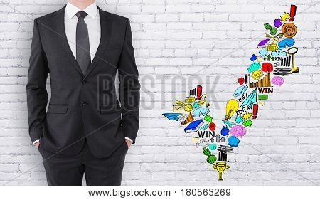Young businessman on white birck background with business sketch. Approval concept