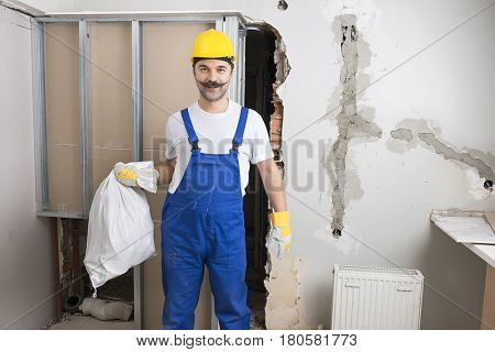 Happy Construction Worker Carrying Poly Bag  