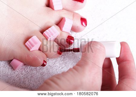 Close-up of female feet with red polished nails carefree chiropody