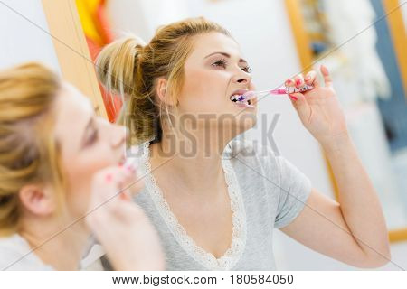 Woman Brushing Cleaning Teeth In Bathroom