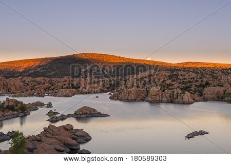 a full moon rising over scenic Watson lake Prescott Arizona