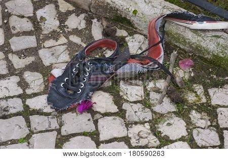 old broken sneaker abandoned in the street of Lisbon, Portugal
