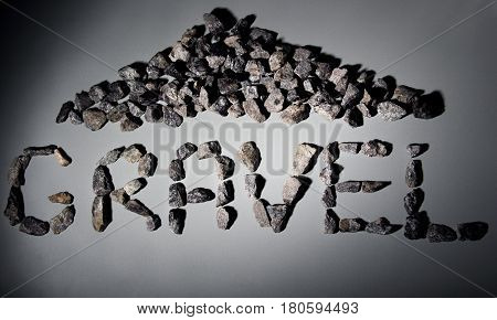 Letters From Gravel On Gray Background. Wrote Gravel.copy Space