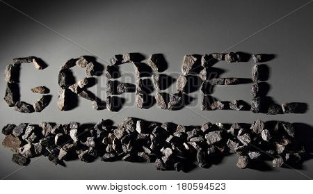 Letters From Gravel On Gray Background. Wrote Gravel.copy Space