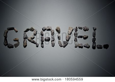 Letters From Gravel On Gray Background. Wrote Gravel.copy Space