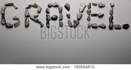 Letters From Gravel On Gray Background. Wrote Gravel.copy Space