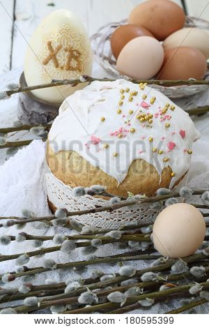 Easter cake with colored eggs and willow twigs on a wooden table, Easter cake
