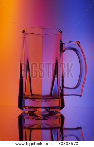 Still life with glass wineglass of beer. Illumination through colored filters