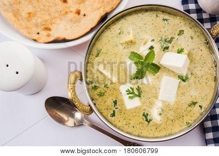 methi malai paneer or Creamy Fenugreek & Paneer Curry, popular north indian recipe prepared using milk cream, methi and paneer or cottage cheese, served with roti/paratha, selective focus