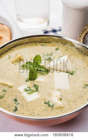 methi malai paneer or Creamy Fenugreek & Paneer Curry, popular north indian recipe prepared using milk cream, methi and paneer or cottage cheese, served with roti/paratha, selective focus