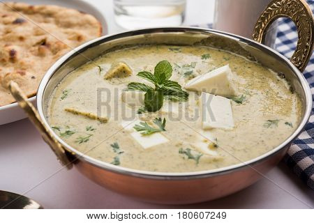 methi malai paneer or Creamy Fenugreek & Paneer Curry, popular north indian recipe prepared using milk cream, methi and paneer or cottage cheese, served with roti/paratha, selective focus