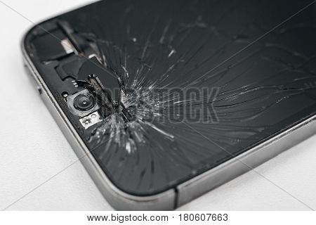 Broken mobile phone screen close up. Broken front camera