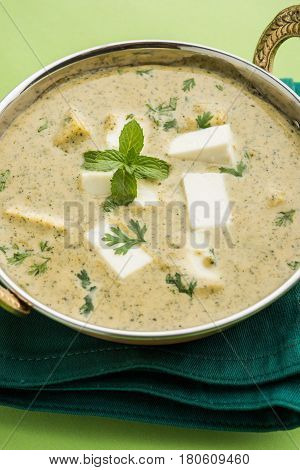 methi malai paneer or Creamy Fenugreek & Paneer Curry, popular north indian recipe prepared using milk cream, methi and paneer or cottage cheese, served with roti/paratha, selective focus