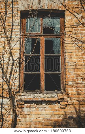 View of an old abandoned log house, finished with a plaster in a village.