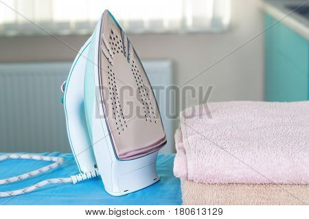 Housework ironing iron colorful towels on the ironing board