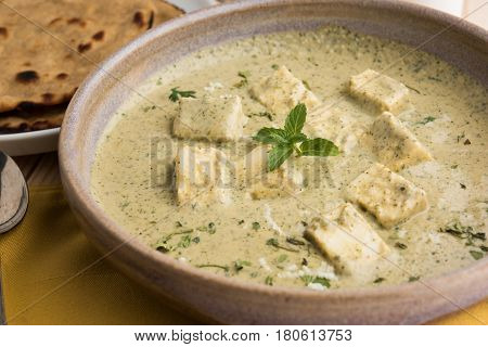 methi malai paneer or Creamy Fenugreek & Paneer Curry, popular north indian recipe prepared using milk cream, methi and paneer or cottage cheese, served with roti/paratha, selective focus