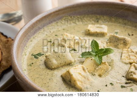 methi malai paneer or Creamy Fenugreek & Paneer Curry, popular north indian recipe prepared using milk cream, methi and paneer or cottage cheese, served with roti/paratha, selective focus