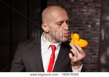 Special agent kissing little toy duck