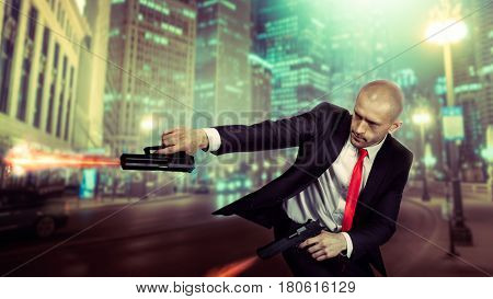 Bald assassin in suit and red tie shoot a pistols
