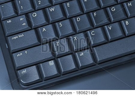 Black laptop keyboard close up as background