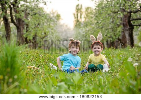 Two Little Kids Boys And Friends In Easter Bunny Ears During Tra