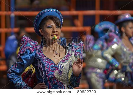 ORURO, BOLIVIA - FEBRUARY 26, 2017: Caporales dancers in ornate costumes performing as they parade through the mining city of Oruro on the Altiplano of Bolivia during the annual carnival.