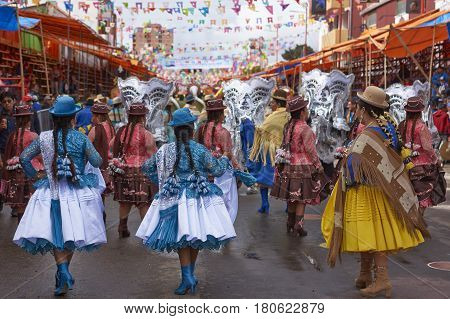 ORURO, BOLIVIA - FEBRUARY 26, 2017: Morenada dance group in colourful outfits parading through the mining city of Oruro on the Altiplano of Bolivia during the annual Oruro Carnival.