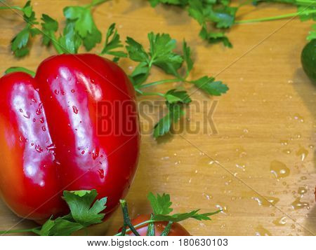 The fresh vegetables on the wooden table close-up