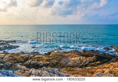 The sea and the rocks with sky an clouds.