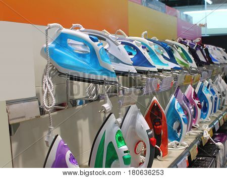 Many irons in the multi-colored showcase are waiting for their buyer to stand in a row