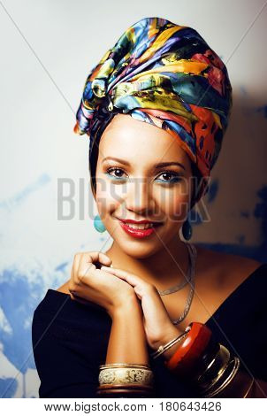 beauty bright real african woman with creative make up, shawl on head like cubian closeup smiling