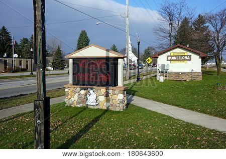 MANCELONA, MICHIGAN / UNITED STATES - NOVEMBER 27, 2016: An electric sign along US Highway 131, outside the information booth in Railroad Park, welcomes travelers and visitors to Mancelona.