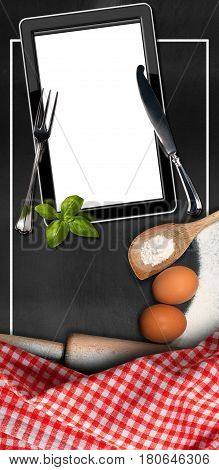 Empty tablet computer in the kitchen (empty blackboard) with utensils flour eggs silver cutlery and a checkered tablecloth