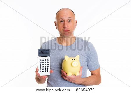 Man In Gray Shirt With Pocket Calculator And Piggybank