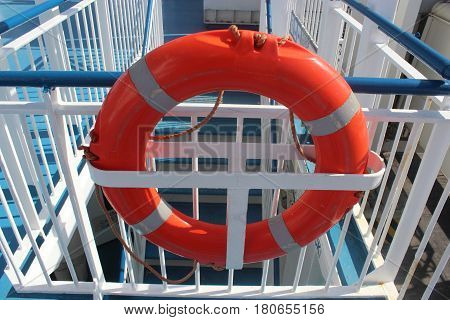 orange life buoy on the railing of a ship