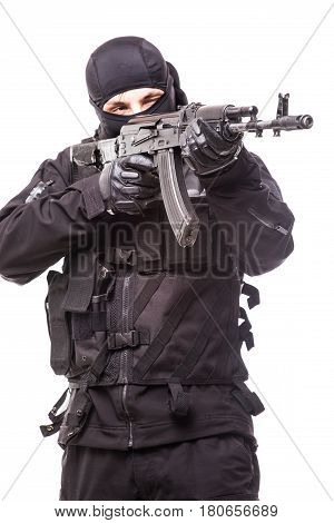 Armed Terrorist In Black Mask And Black Uniform Aiming With A Gun. Portrait Of Good Or Bad Guy
