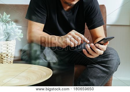 Designer Man Hand Using Smart Phon For Mobile Payments Online Shoppingomni Channelsitting On Sofa In